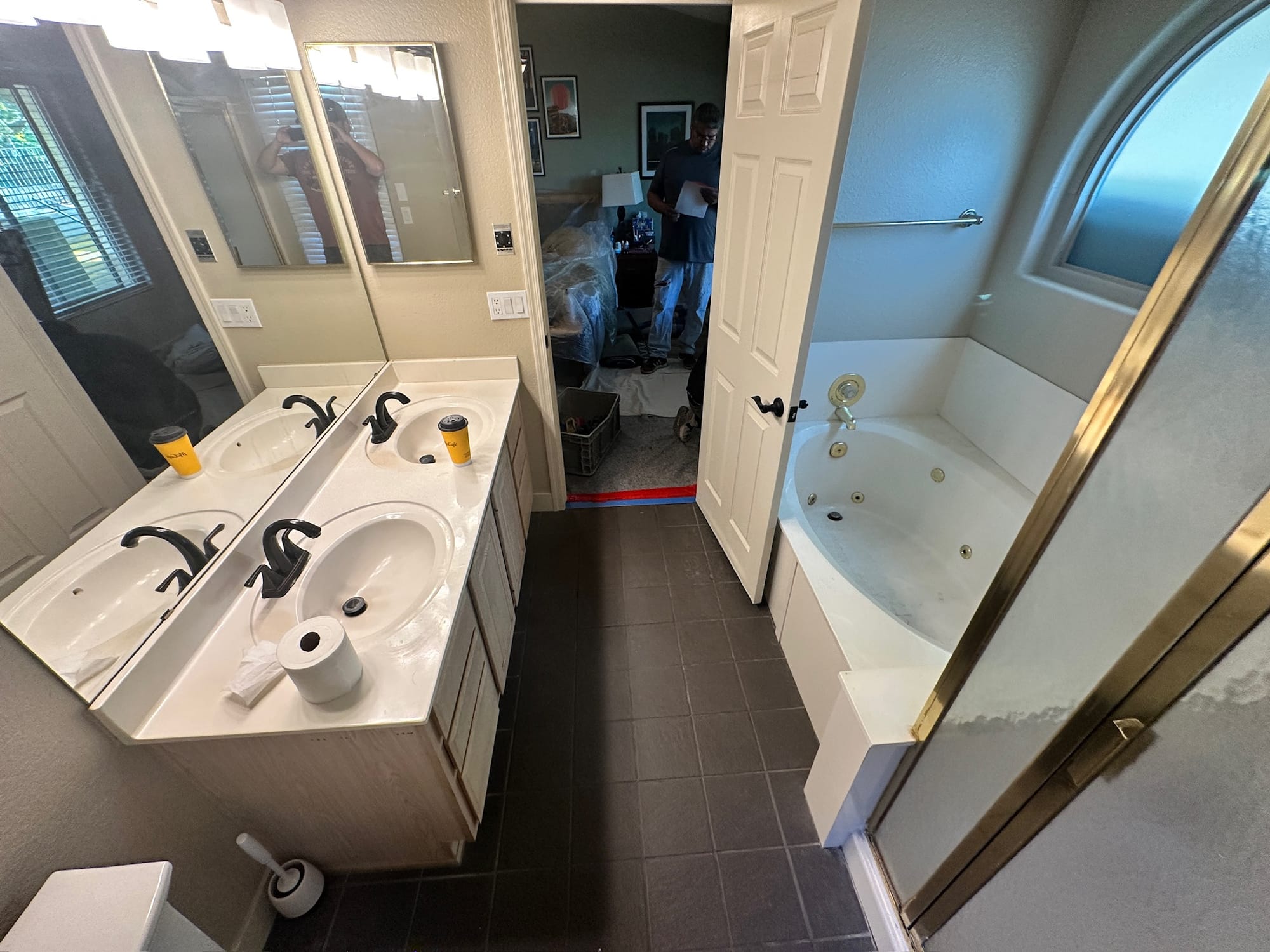 Ahwatukee master bathroom before — wider view showing dated vanity in foreground and garden tub in background