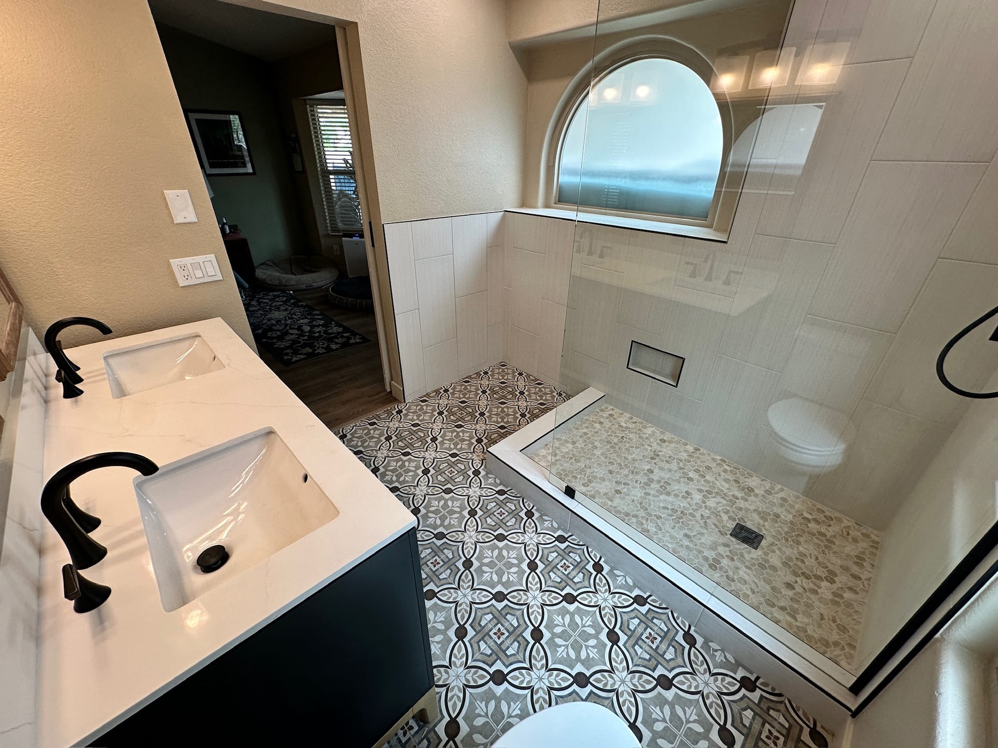 Ahwatukee bathroom — vanity in foreground with the new shower visible behind the arched window