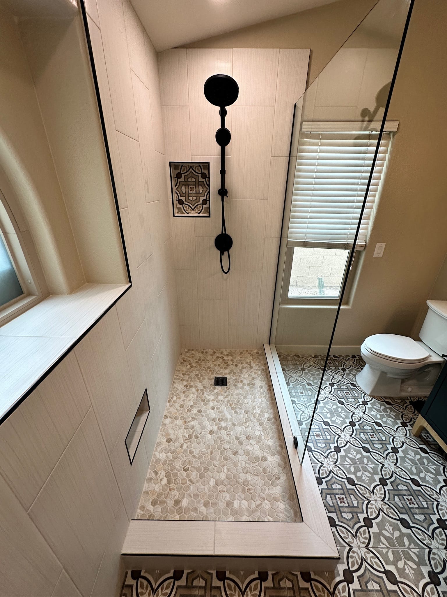 Ahwatukee bathroom — interior view of the extended walk-in shower with niche and pebble shower floor
