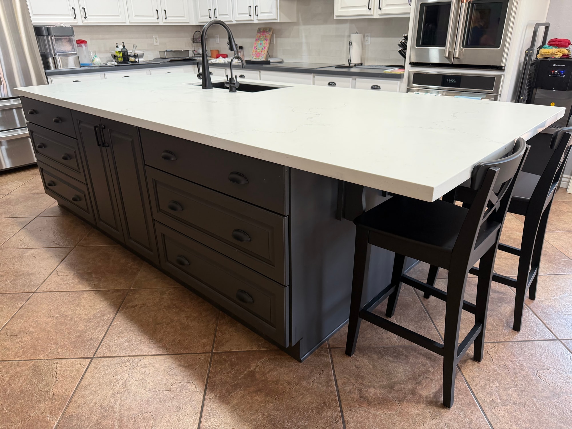 Chandler kitchen — close-up of the island drawer banks in Sollid Custom Series Revere, Midnight Sun Matte grey finish, with black cup pulls on every drawer
