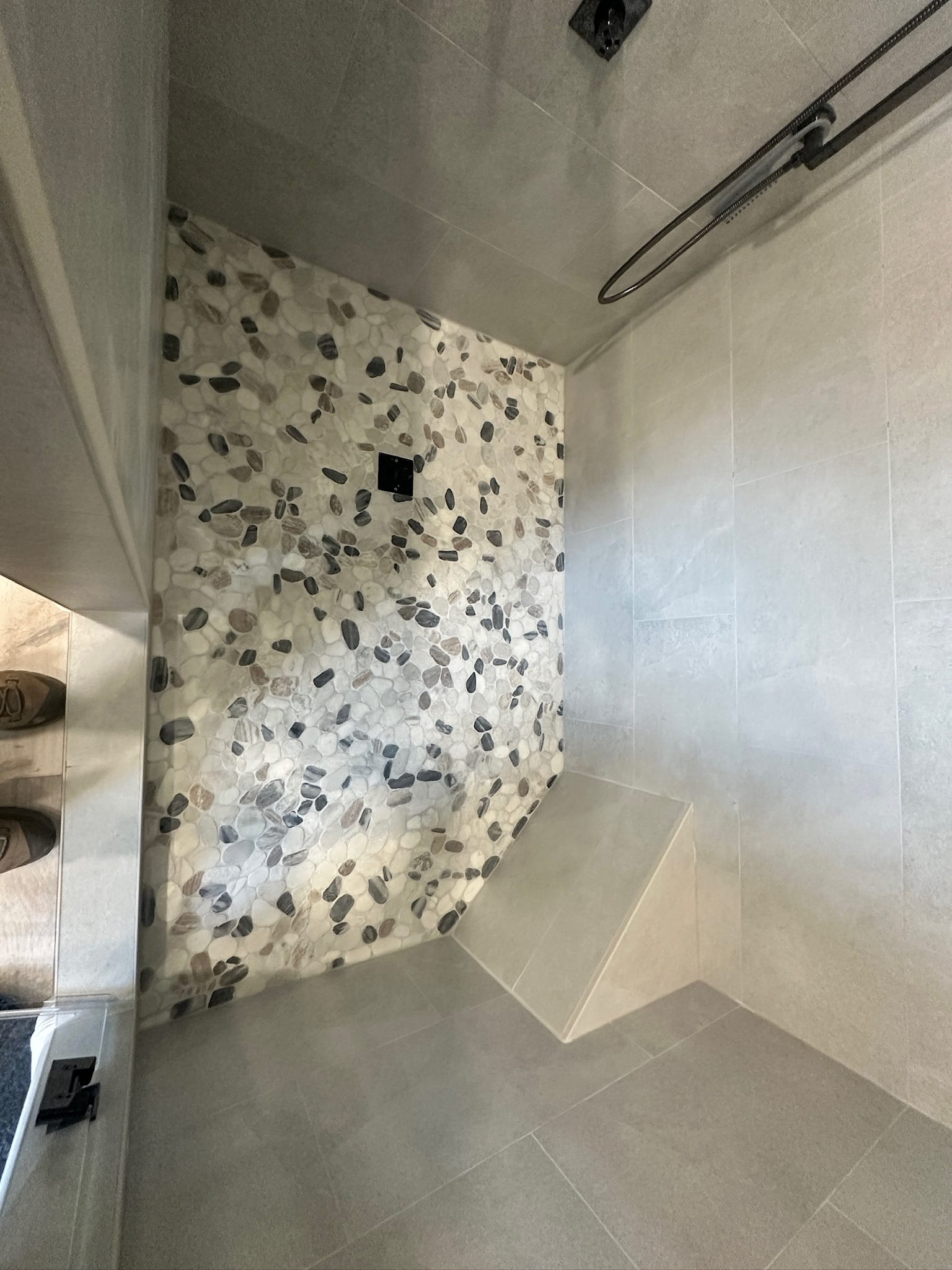 Gilbert bathroom — close-up of sliced-pebble mosaic accent wall in the walk-in shower