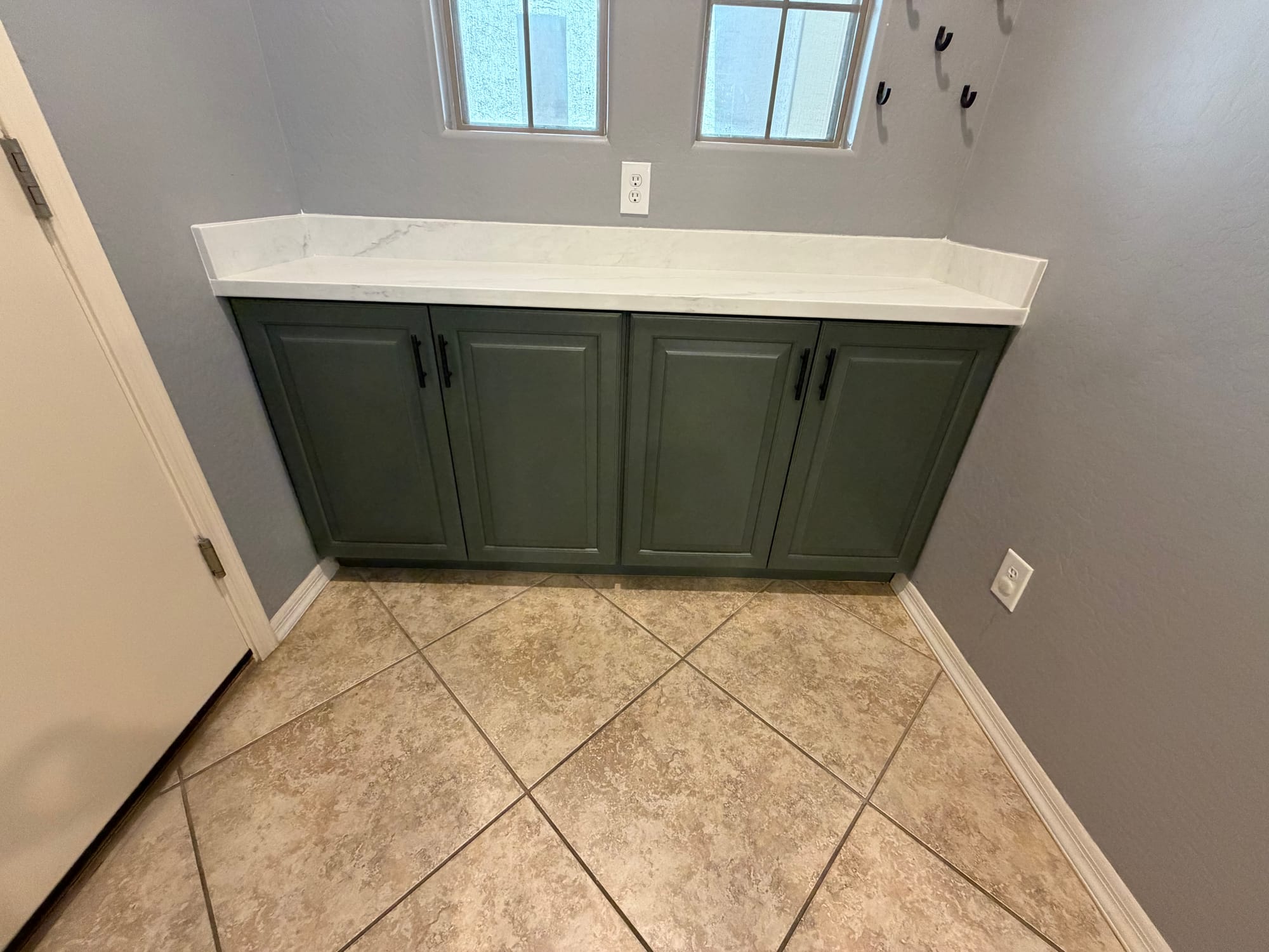 Gilbert kitchen after — sage side cabinets with Della Terra quartz top in the utility area