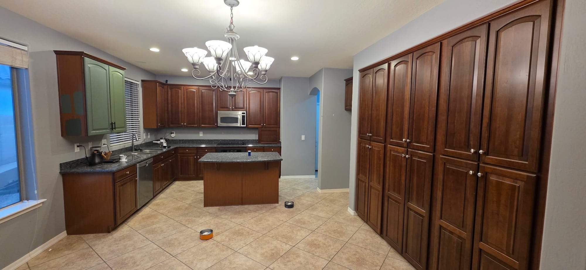 Gilbert kitchen before — sink area with the original dark cherry raised-panel cabinets
