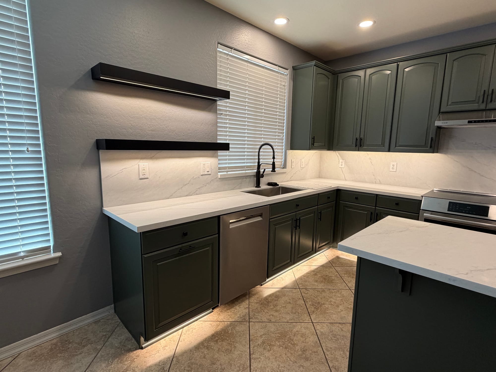Gilbert kitchen — Sollid black floating shelves with under-shelf LED lighting over the sink, set against the Della Terra quartz backsplash