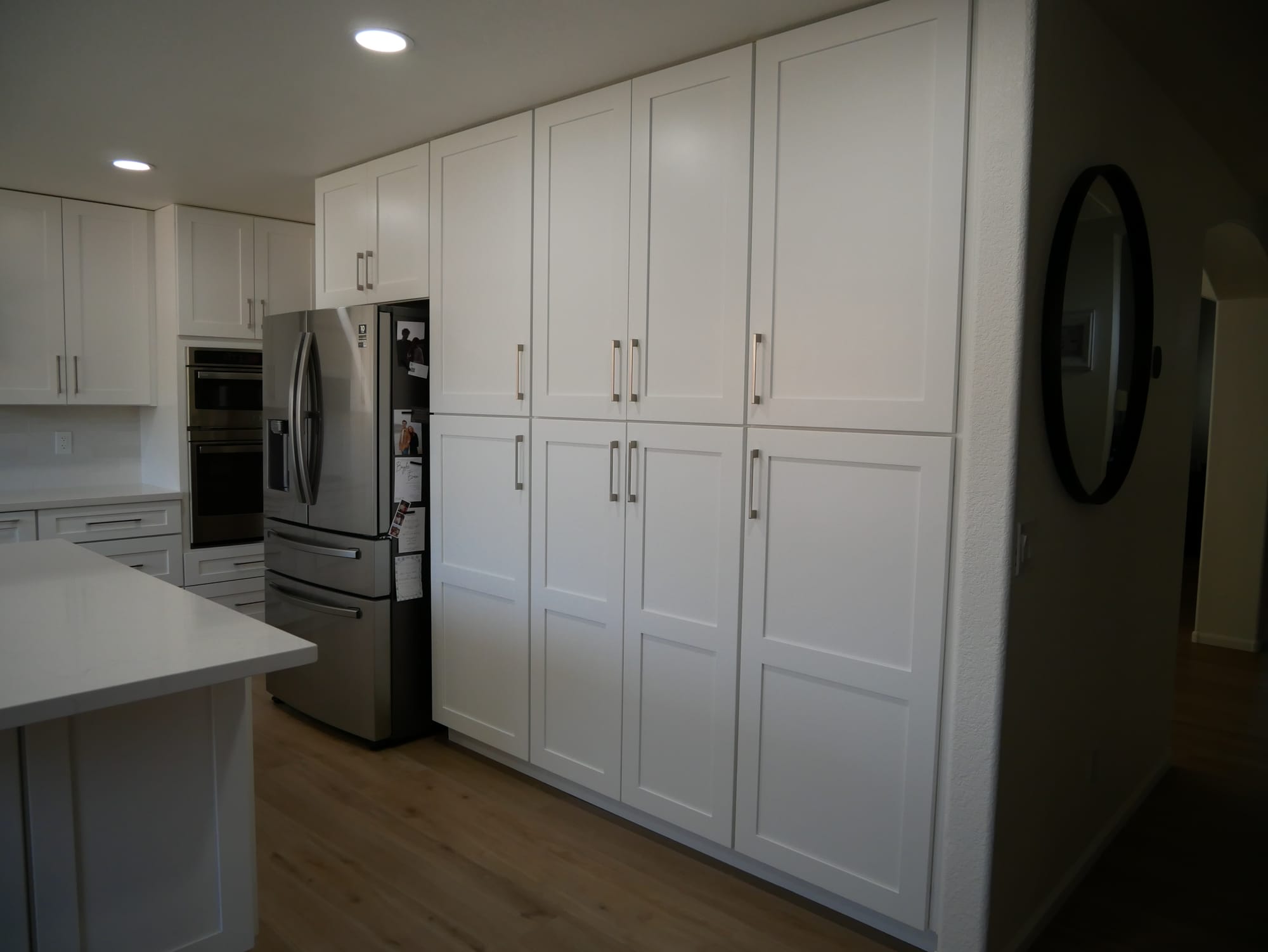 Classic white kitchen — Della Terra quartz countertops and subway tile to ceiling