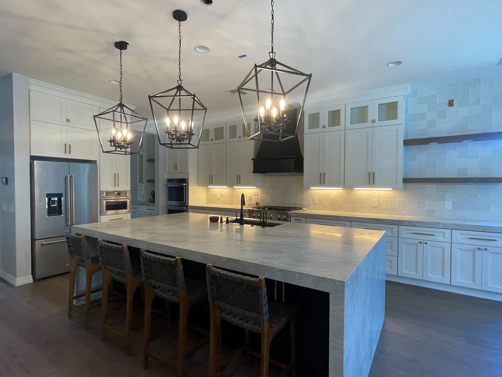 Mesa kitchen after — Taj Mahal quartzite waterfall island with seating for four