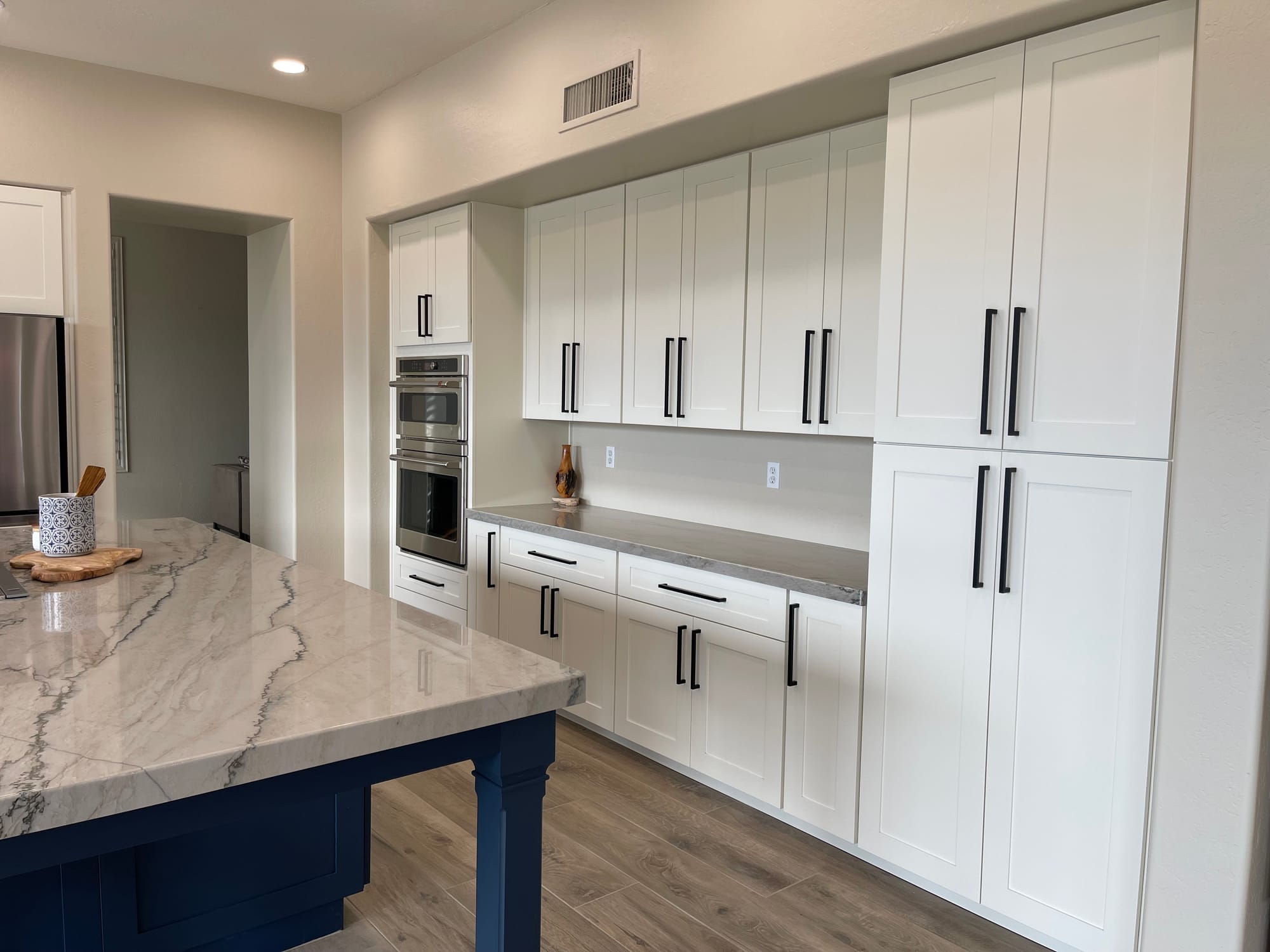 Scottsdale kitchen after remodel — white shaker cabinets with navy island