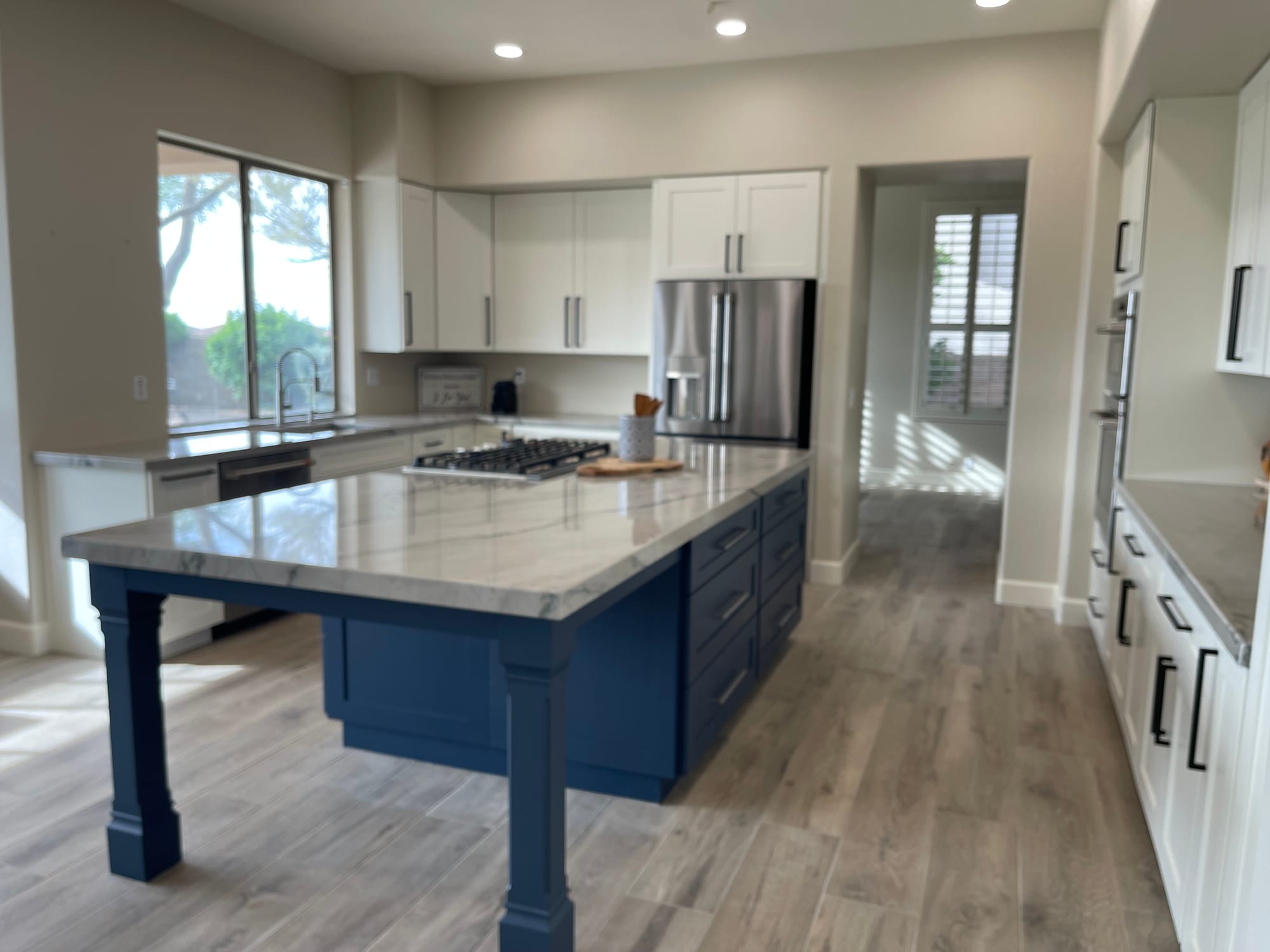Scottsdale kitchen after — Calacatta quartzite countertops and wood-look tile