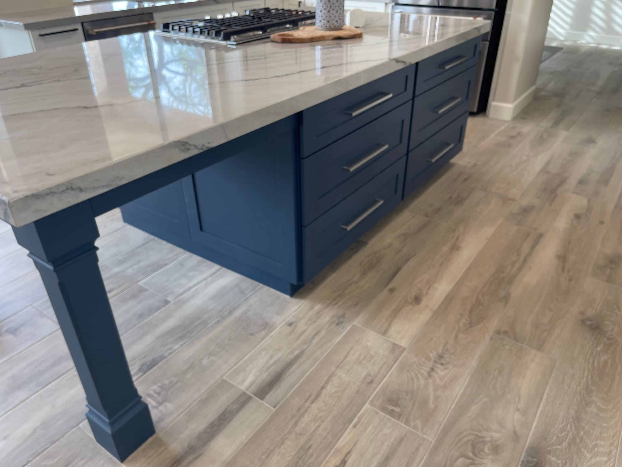 Scottsdale kitchen island — navy blue Sollid cabinetry with quartzite top