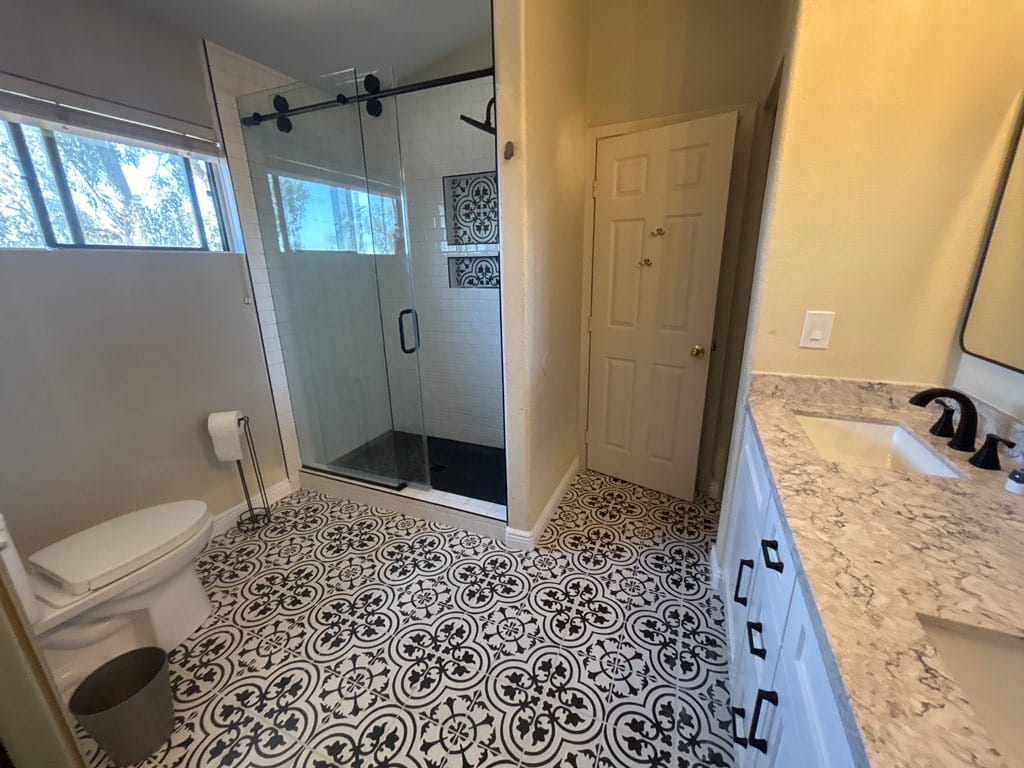 Subway-inspired Scottsdale master bathroom — Sollid 3 Series Shaker White vanity, custom subway tile walk-in shower, and patterned cement-look tile floor