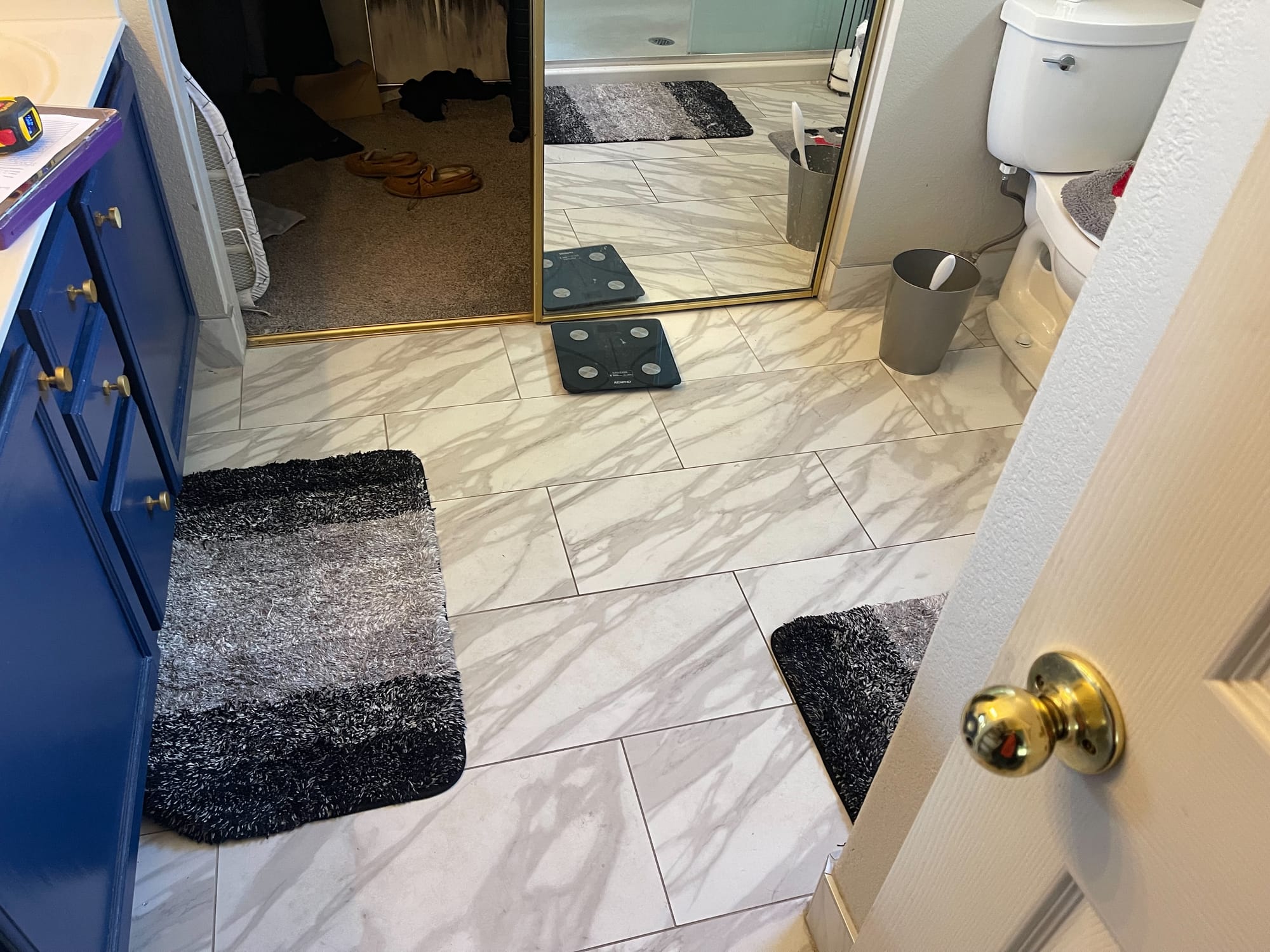 Scottsdale master bathroom before — old navy blue vanity with cultured marble countertop and gold-framed mirrors