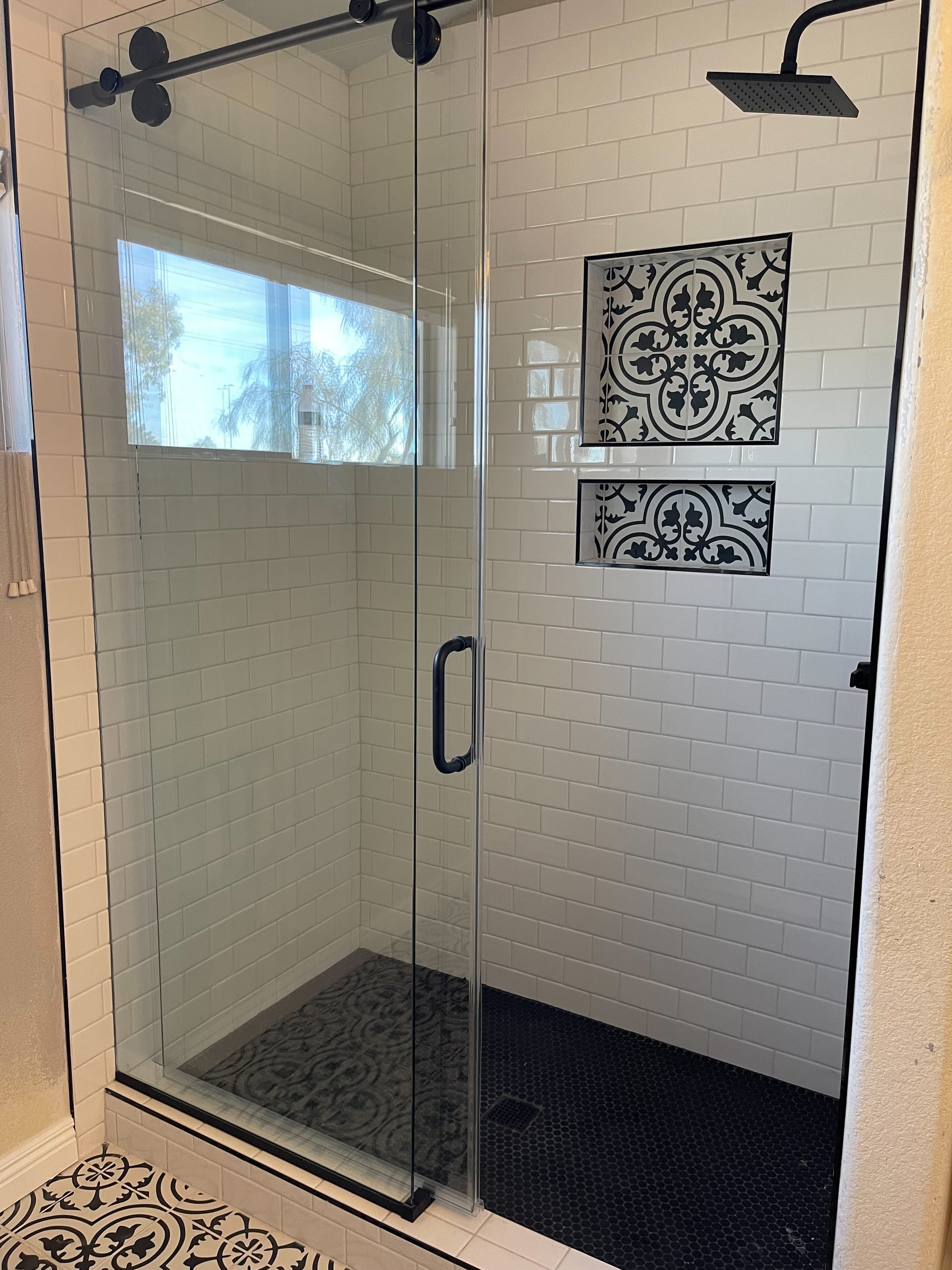 Scottsdale bathroom — subway tile shower at angle showing the patterned cement-tile niches and matte black hardware