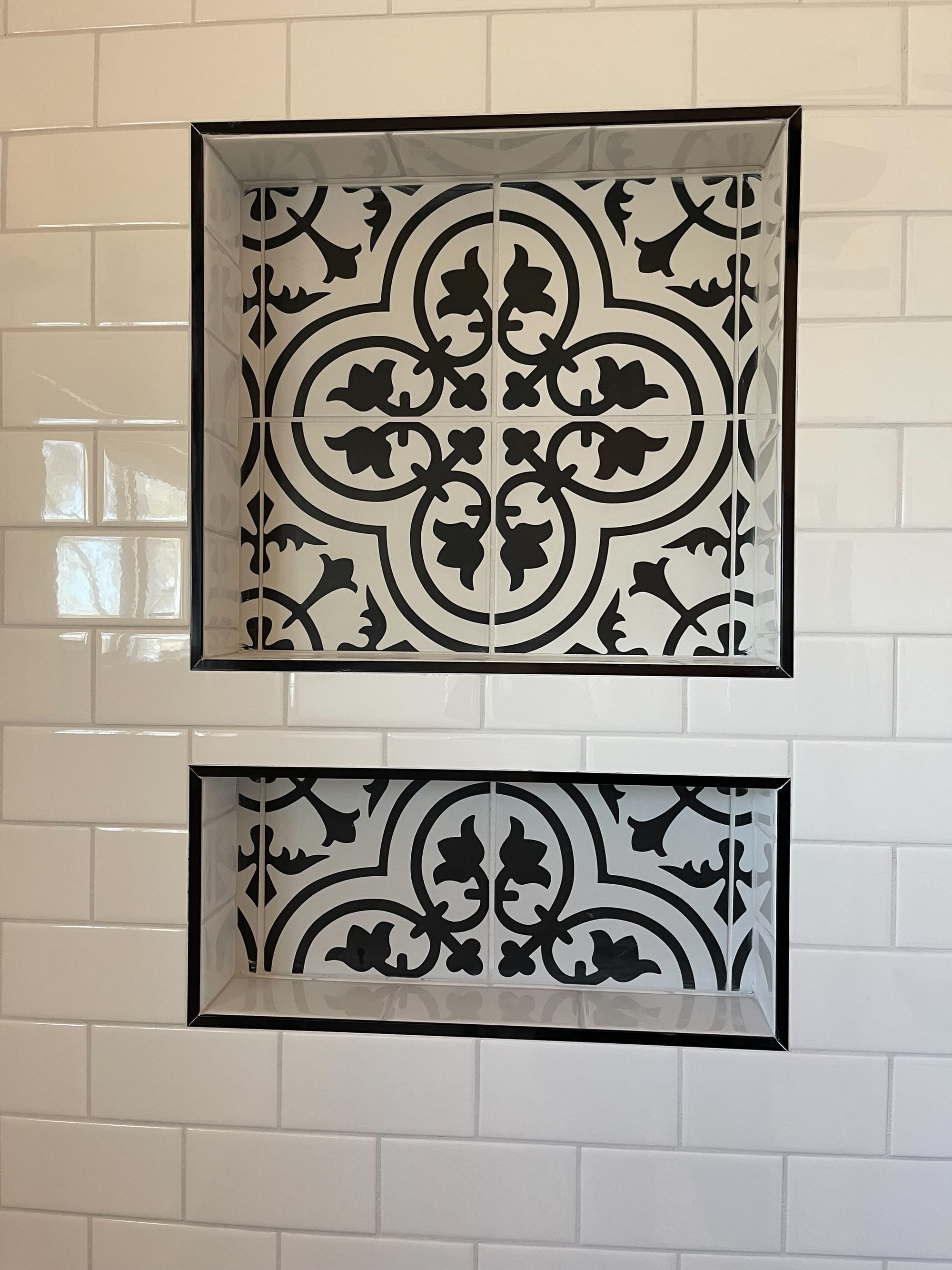 Scottsdale bathroom — close-up of the patterned cement-tile niche accent set into the white subway tile shower wall
